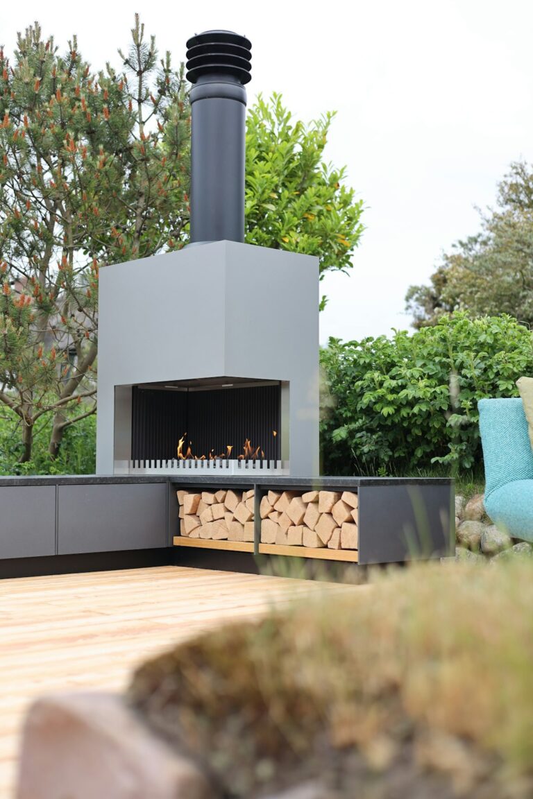 Friends gathered on a shaded patio with comfortable seating, string lights overhead, and outdoor dining in progress.