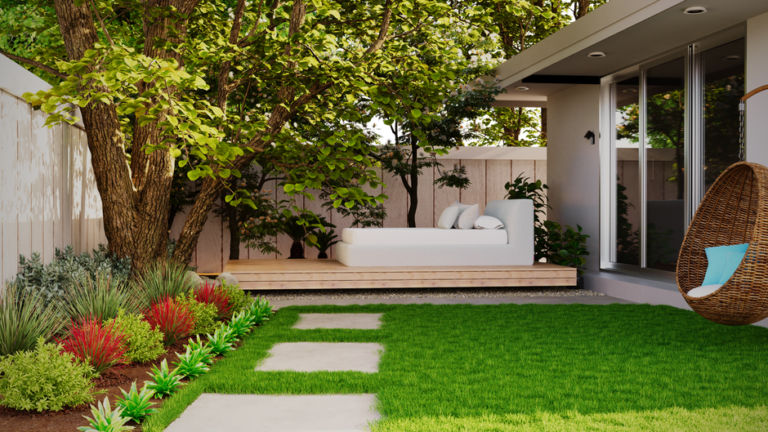 Woman planting hostas and ferns in a shaded backyard garden bed under mature deciduous trees