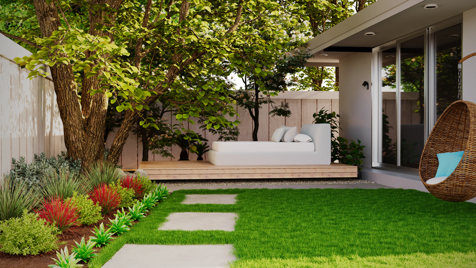 Woman planting hostas and ferns in a shaded backyard garden bed under mature deciduous trees