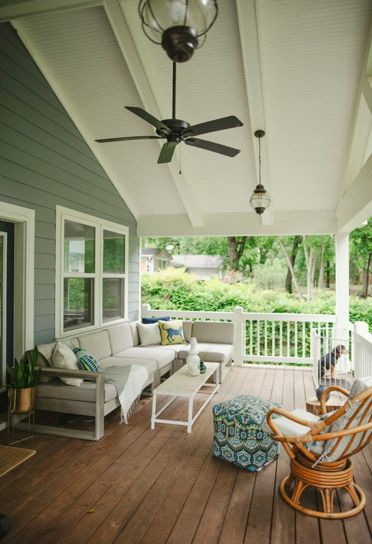 Covered patio with ceiling fan, screened sides, outdoor seating, cushions, and a dry paved floor